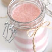 Jar filled with layered candy cane sugar scrub